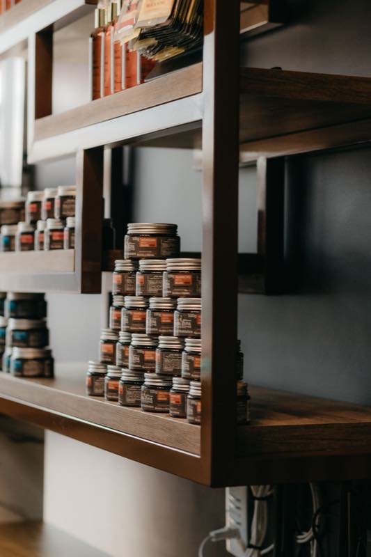 Hair care products arranged on a wooden shelf