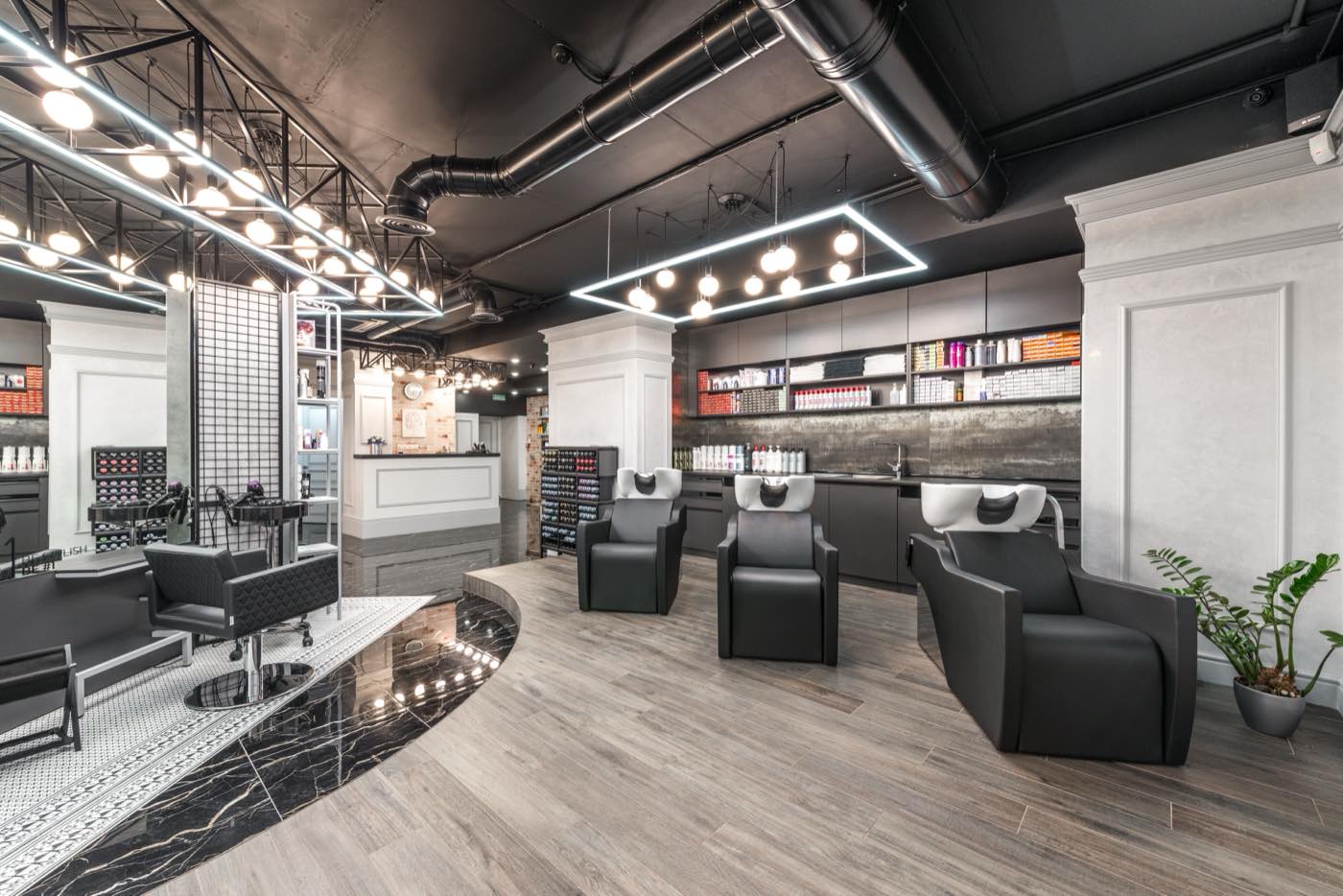The salon interior with styling chairs, mirrors and warm overhead lighting